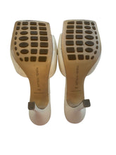 Load image into Gallery viewer, Bottom sole view of Bottega Veneta cream heel mules, size 40
